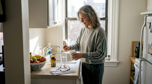 Woman prepares supplements during morning kitchen routine