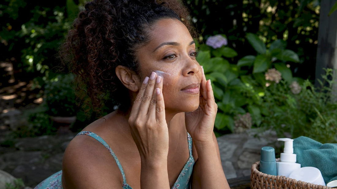 Woman applying sunscreen in bathroom
